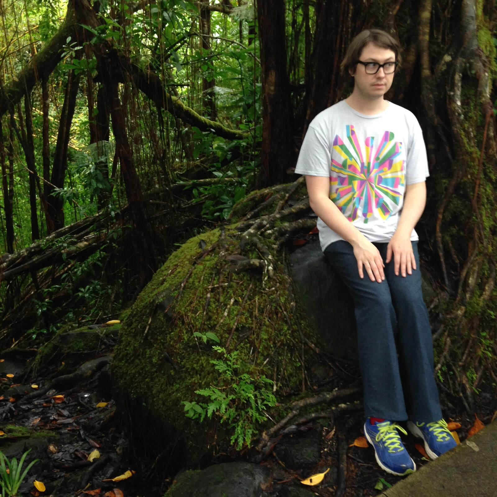 A photograph of Wiley Wiggins at the edge of a rainforest